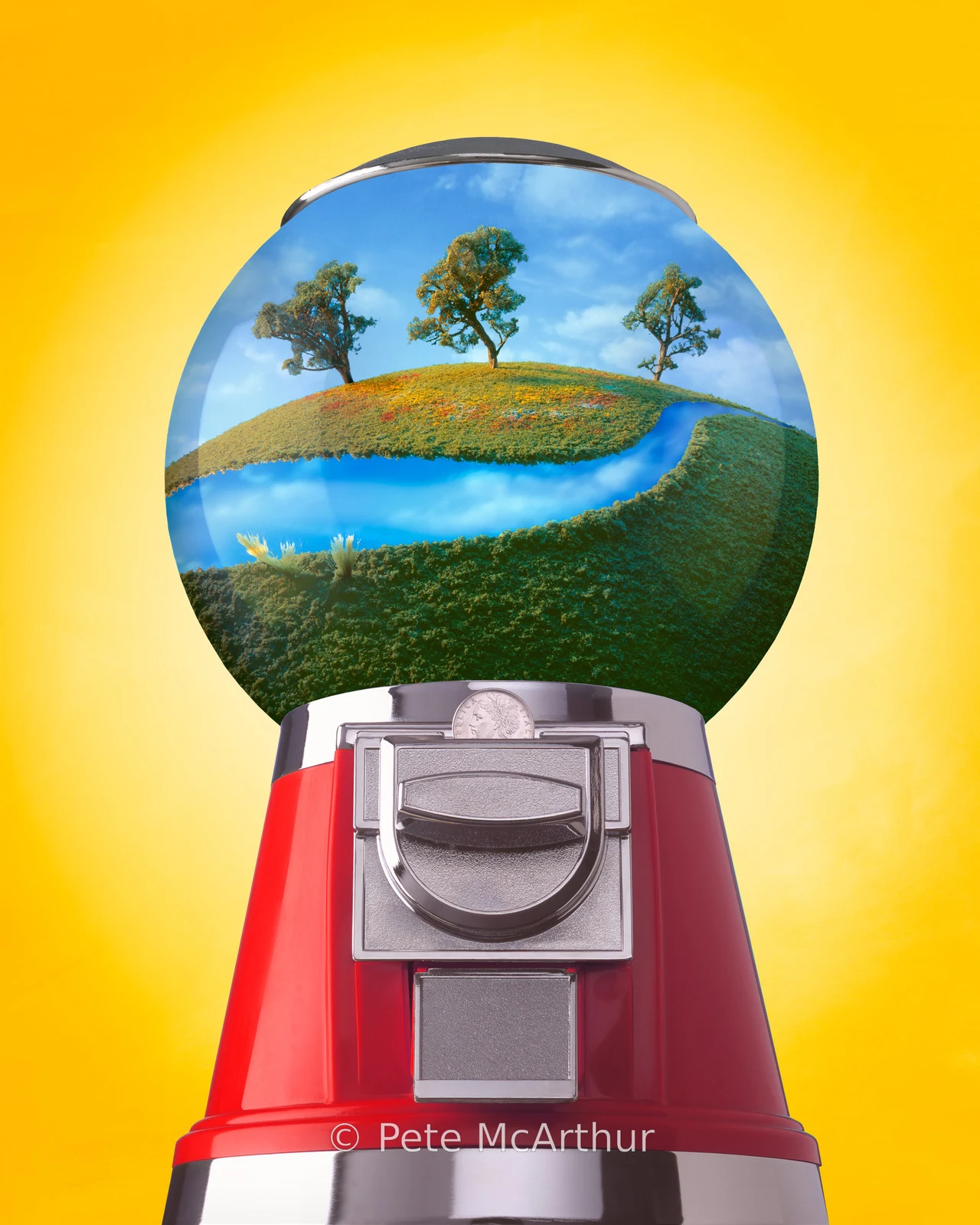 A red gumball machine contains a miniature landscape with water, grass and trees inside its globe.
